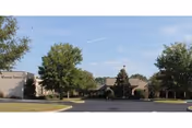 Exterior view of Westside Terrace Healthcare with trees and a parking area.