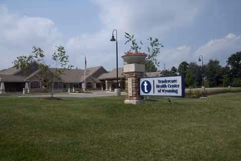 Exterior view of Medilodge of Wyoming with front lawn and entrance sign