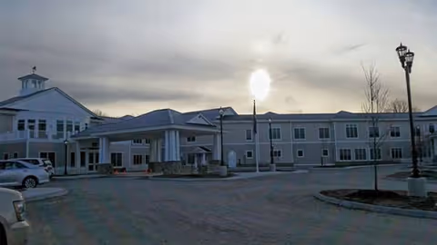 Exterior view of Seaport Village Healthcare facility with entrance and parking lot.