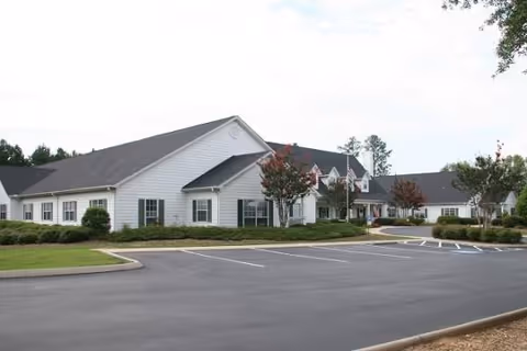 Front view of Greenville Glen senior living facility with parking lot