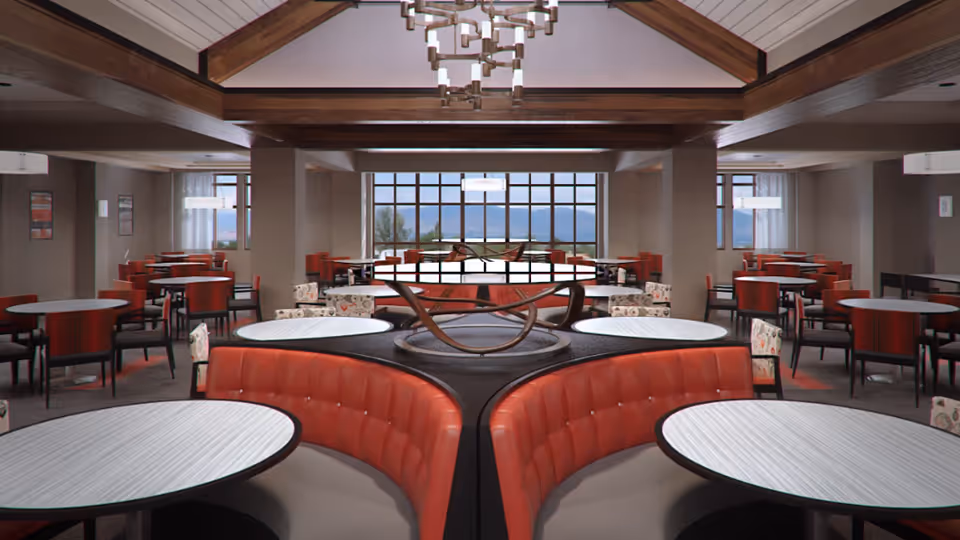 Spacious dining room with multiple round tables and red cushioned chairs arranged neatly. The room features large windows with a view of mountains in the distance, wooden ceiling beams, and modern light fixtures.