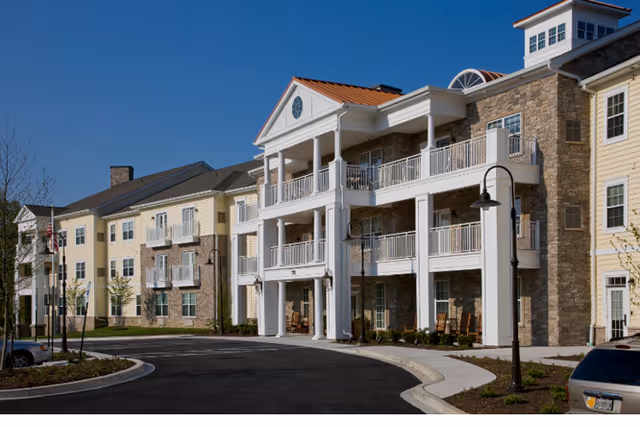 Exterior view of Brightview Avondell senior living building with balconies and curved driveway.