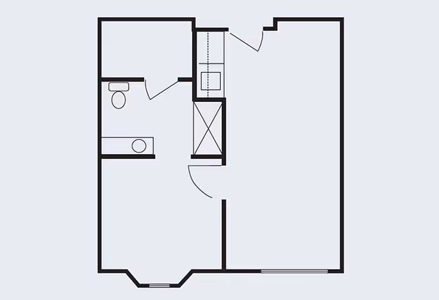 Floor plan layout of a small apartment or unit showing a bathroom with toilet and sink, a closet, and a larger open living space with an entrance door.