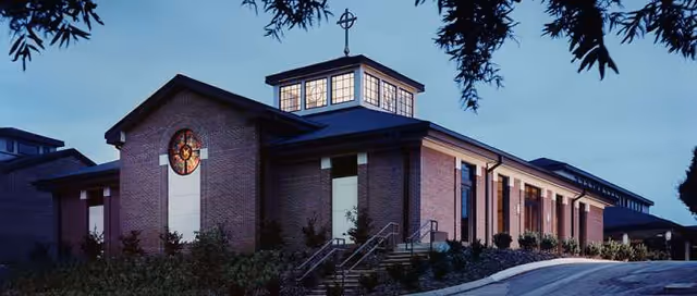 Brick retirement community exterior with a stepped entrance and multiple windows.