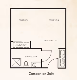 Floor plan layout of a companion suite showing two bedrooms, a living room, a bathroom with a shower, toilet, and sink, and two closets.