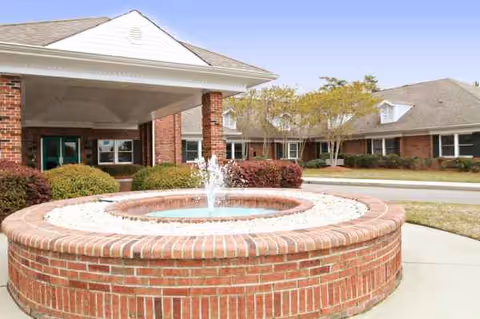 Circular brick fountain in front of Village Green Health and Rehabilitation facility.