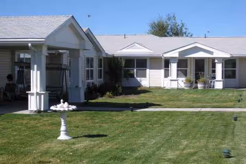 Exterior view of Prairie House Assisted Living, with lawn and front entrance.