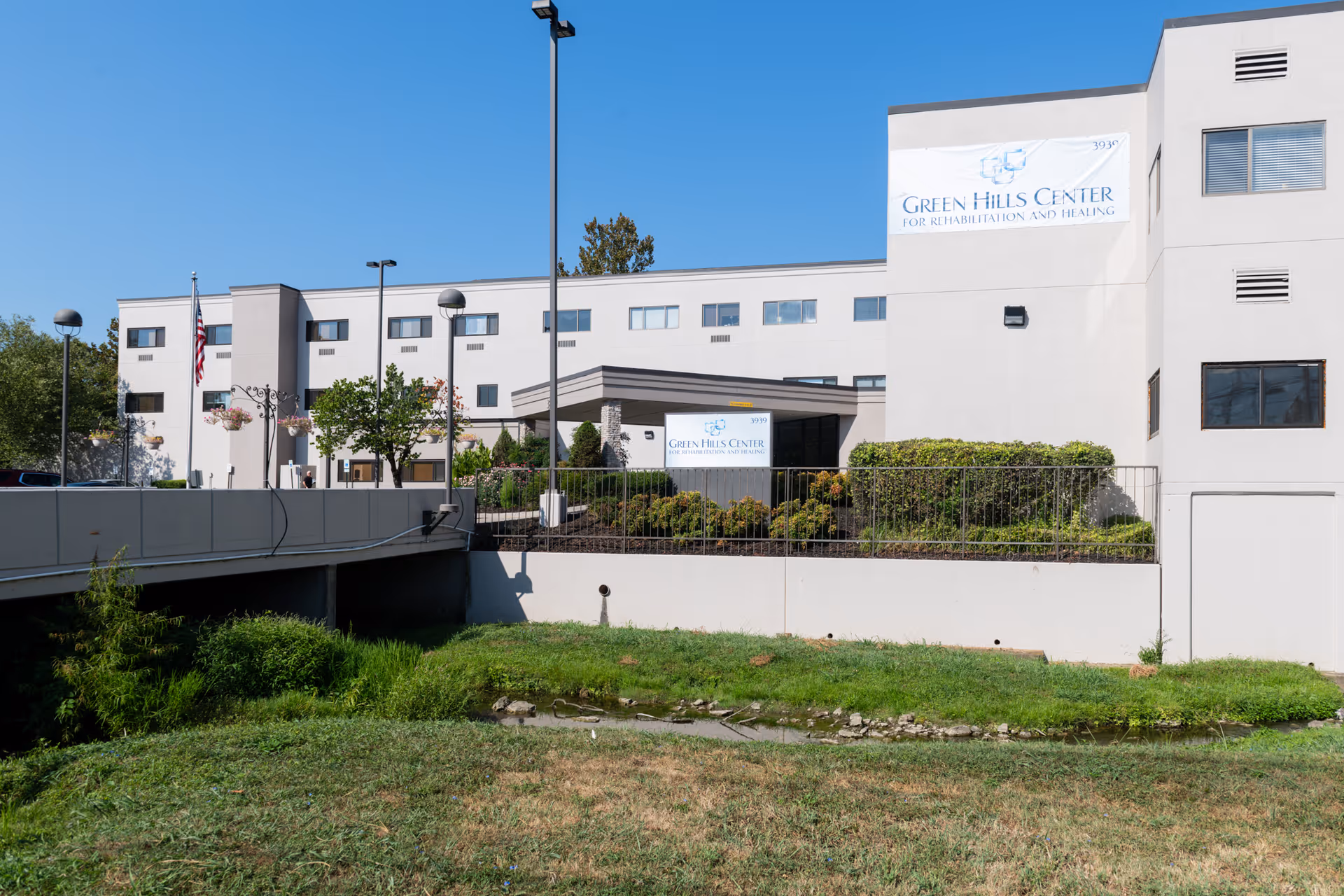 Front exterior of the Green Hills Center for Rehabilitation and Healing building showing the entrance canopy, signage, and landscaped lawn.