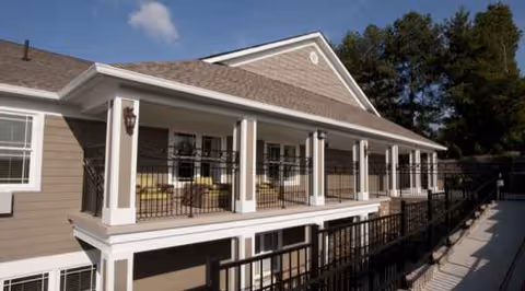 Exterior view of Autumn Care West with a covered porch and railing