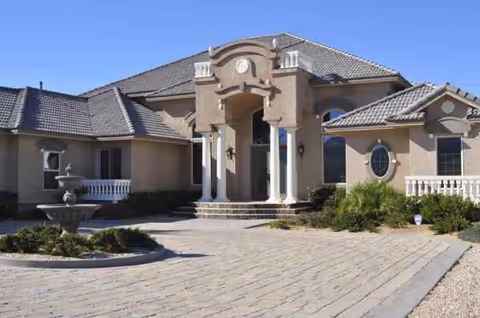Front exterior of High Desert Residential Care featuring a grand entrance with columns.