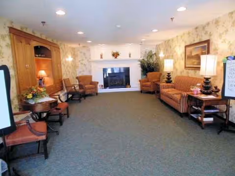 Living room lounge at Evans Memorial Home with fireplace and multiple seating areas