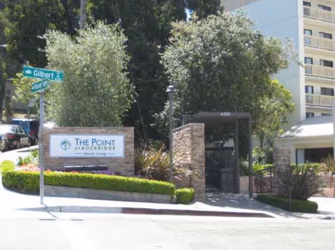 Exterior view of The Point at Rockridge Senior Living entrance with stone pillars.