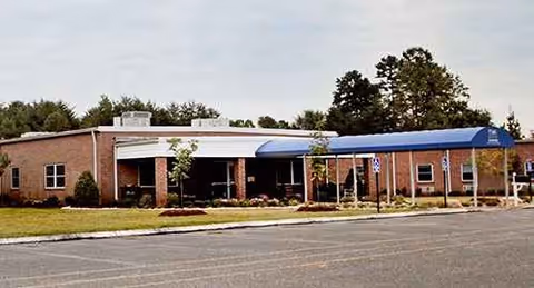 Front exterior of Highland Heights Health & Rehabilitation with blue canopy and parking.