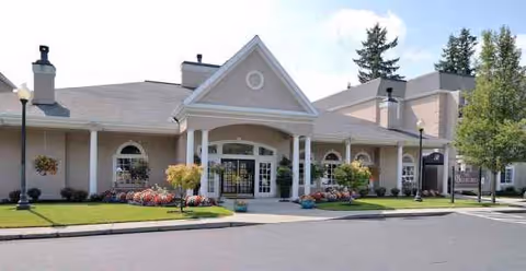 Truewood by Merrill Vancouver entrance with arched glass doors and landscaping.