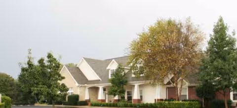 Exterior view of Brookdale Chickasha senior living facility with trees and landscaping