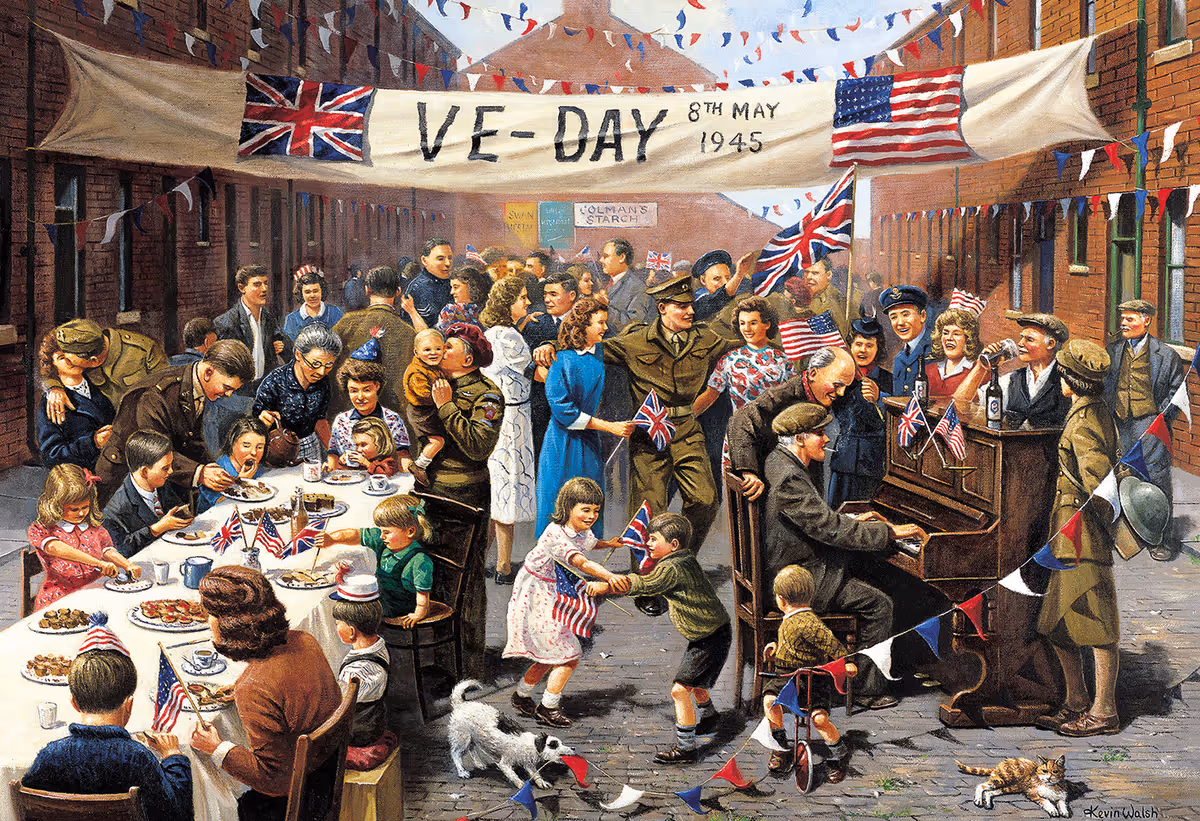 Street scene of a World War II VE-Day celebration with families, soldiers, flags, bunting, a long table of food, and a man playing a piano.