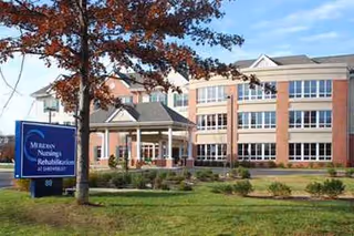 Exterior of Hackensack Meridian Health Nursing and Rehabilitation Shrewsbury with entrance canopy and manicured lawn.