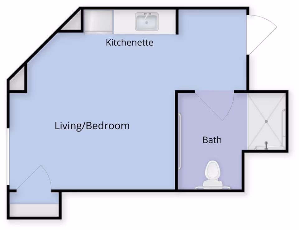 Floor plan of a small living space at Juniper Village at South Hills showing a combined living and bedroom area, a kitchenette with a sink and counter, and a separate bathroom with a toilet and shower.