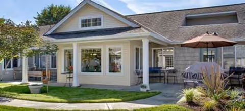 Front view of Brookdale Vancouver Stonebridge building with a covered entrance and outdoor seating.