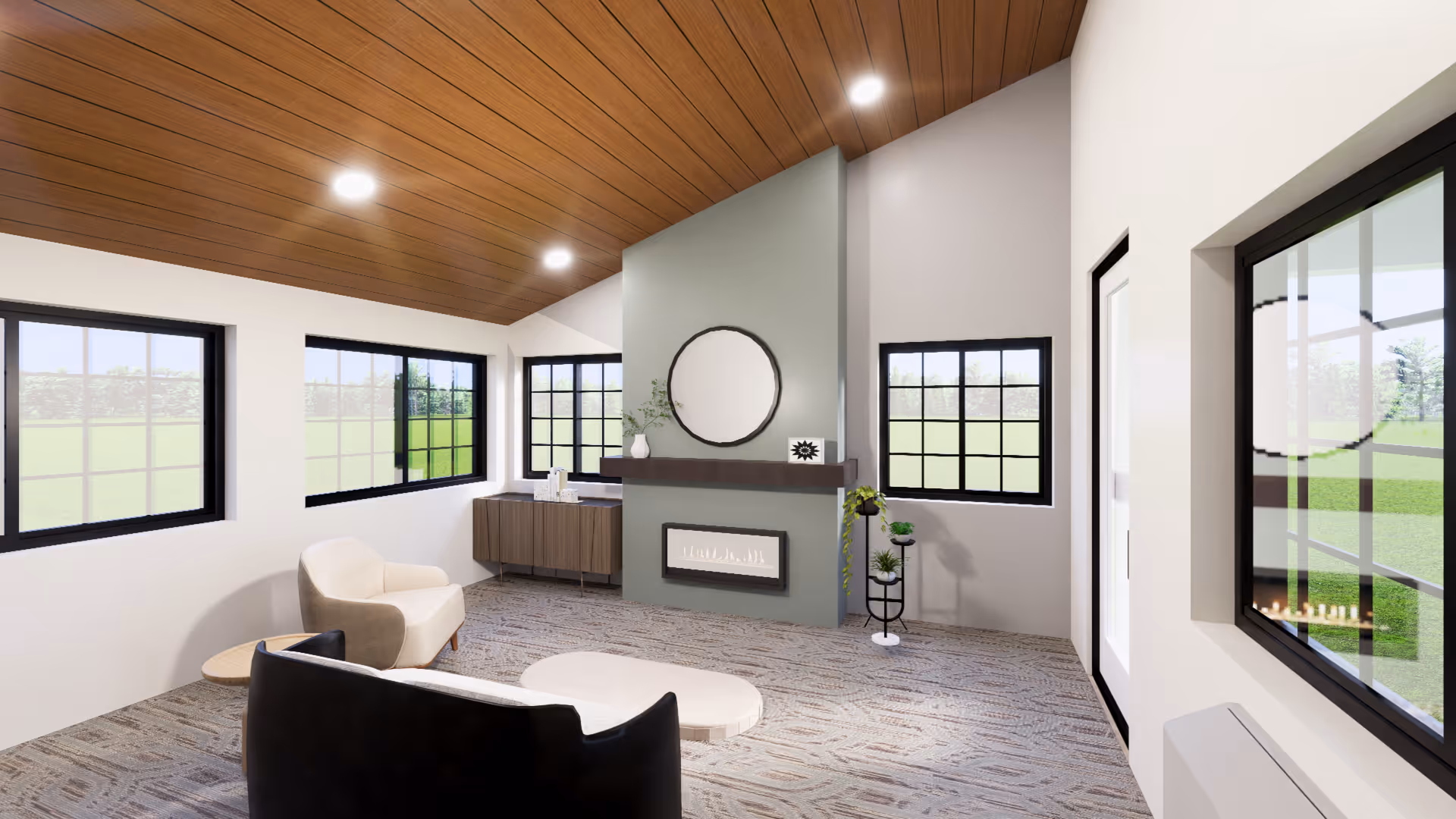 A modern living room with a slanted wooden ceiling and recessed lighting. The room features large black-framed windows letting in natural light, a light beige armchair, a black sofa, and a small round wooden side table. There is a green accent wall with a built-in fireplace, a round mirror above it, and a floating shelf with decorative items. A small cabinet is positioned under the windows, and a plant stand with greenery is placed near the fireplace.