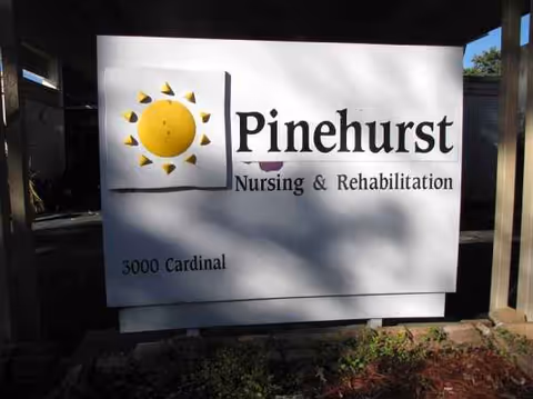 Exterior Pinehurst Nursing & Rehabilitation sign with sun logo and address 3000 Cardinal.