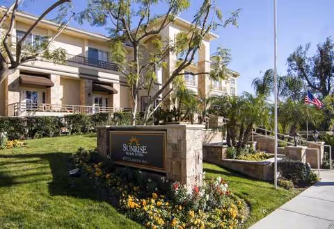 Exterior view of Sunrise of Yorba Linda senior living facility with landscaped entrance.