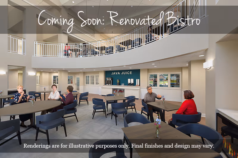 A spacious, modern bistro area with multiple tables and chairs arranged for dining. Several elderly people are seated at tables, engaging in conversation. The room features a high ceiling with a balcony railing above, and a counter labeled 'JAVA JUICE' in the background. The space is well-lit with large windows and wall sconces.