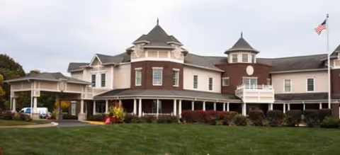 Brookdale Carmel's large multi-story exterior with manicured lawn and flag.