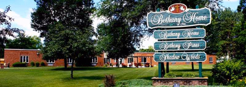 Bethany Pines sign in front of a brick building with trees