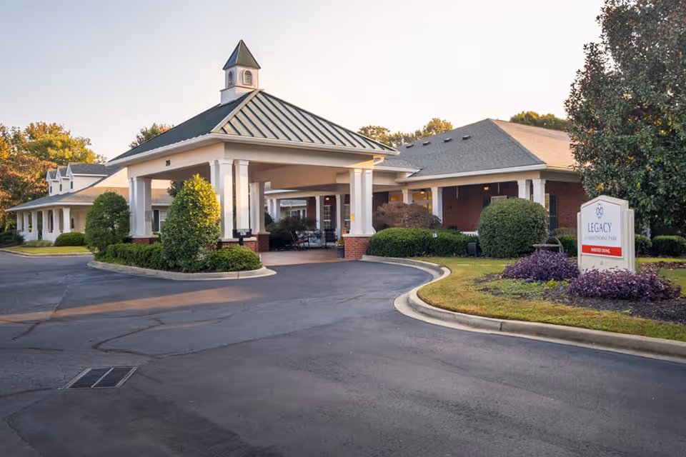 Front view of a single-story assisted living facility with a covered porte-cochère entrance.