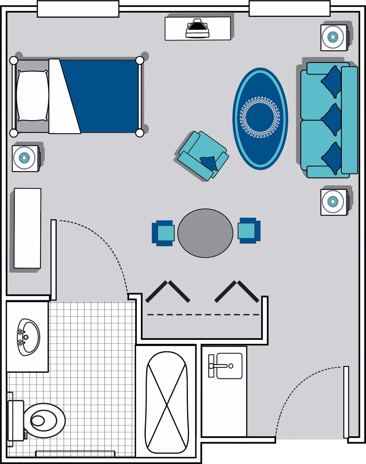 Floor plan of a senior living facility room at Oaks at Evans showing a combined bedroom and living area with a bed, armchair, sofa, coffee table, and two side tables. The room also includes a bathroom with a toilet, sink, and bathtub, and a small kitchenette area with a sink.