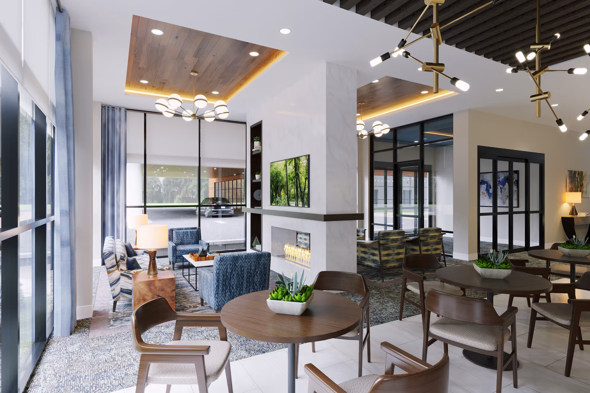 A modern and spacious common area in a senior living facility featuring round wooden tables with chairs, small potted plants on the tables, a central fireplace with a mounted TV above it, comfortable armchairs near large windows, and stylish ceiling lights with wooden panel accents.