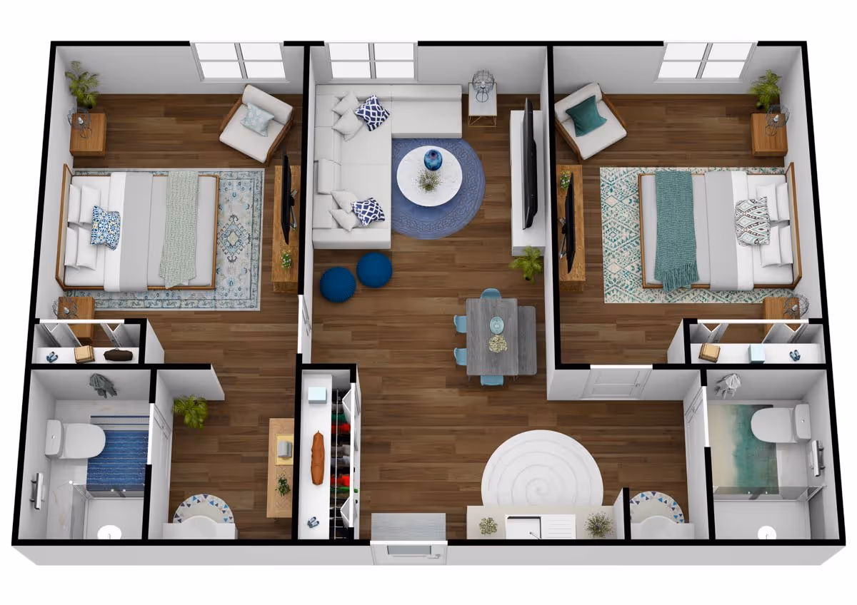 3D floor plan of a senior living apartment featuring two bedrooms, each with a bed, chair, nightstands, and a TV. The central living area includes a sectional sofa, round coffee table, two blue poufs, a TV, and a dining table with four chairs. The apartment has two bathrooms with toilets, sinks, and showers, and a kitchen area near the entrance with a sink and countertop.