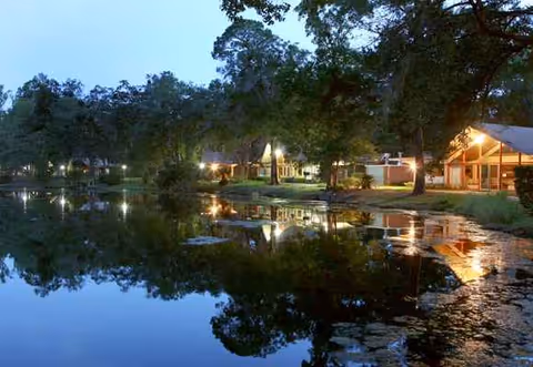 Dusk view of Westminster Woods on Julington Creek exterior beside a tranquil lake.