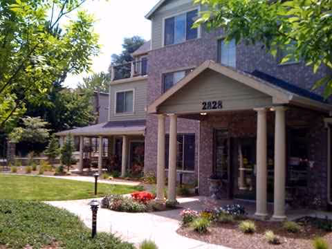 Exterior view of Hawthorne Gardens Senior Living Community entrance with landscaping.