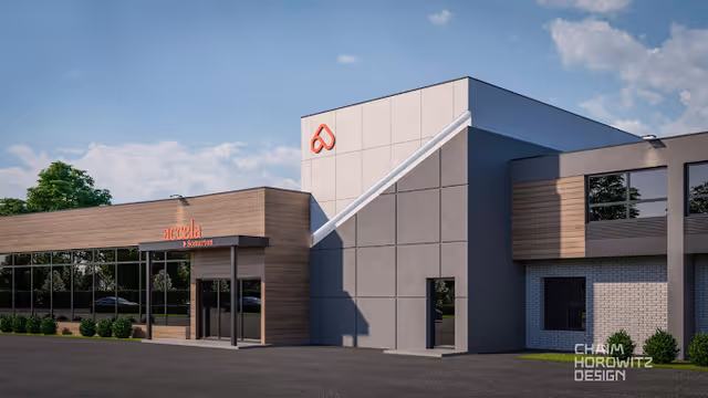Exterior view of Accela Rehab and Care Center at Somerton, showing a modern building with a combination of wood paneling and concrete walls under a partly cloudy sky.