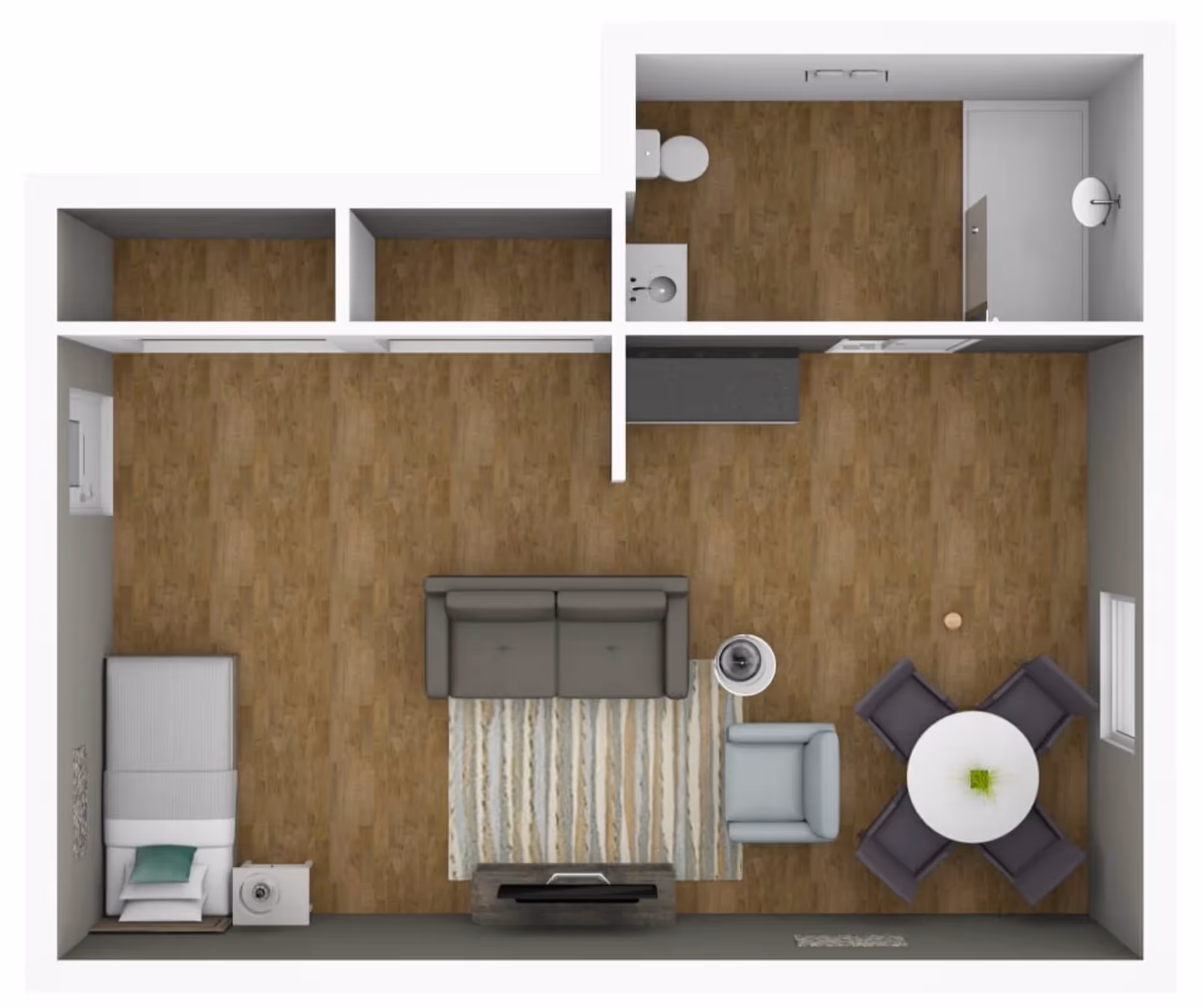 Top-down view of a small apartment floor plan showing a combined living and dining area with a sofa, armchair, TV, round dining table with four chairs, and a single bed with a nightstand. There is a bathroom with a toilet, sink, and shower in the upper right corner. The flooring is wood throughout.
