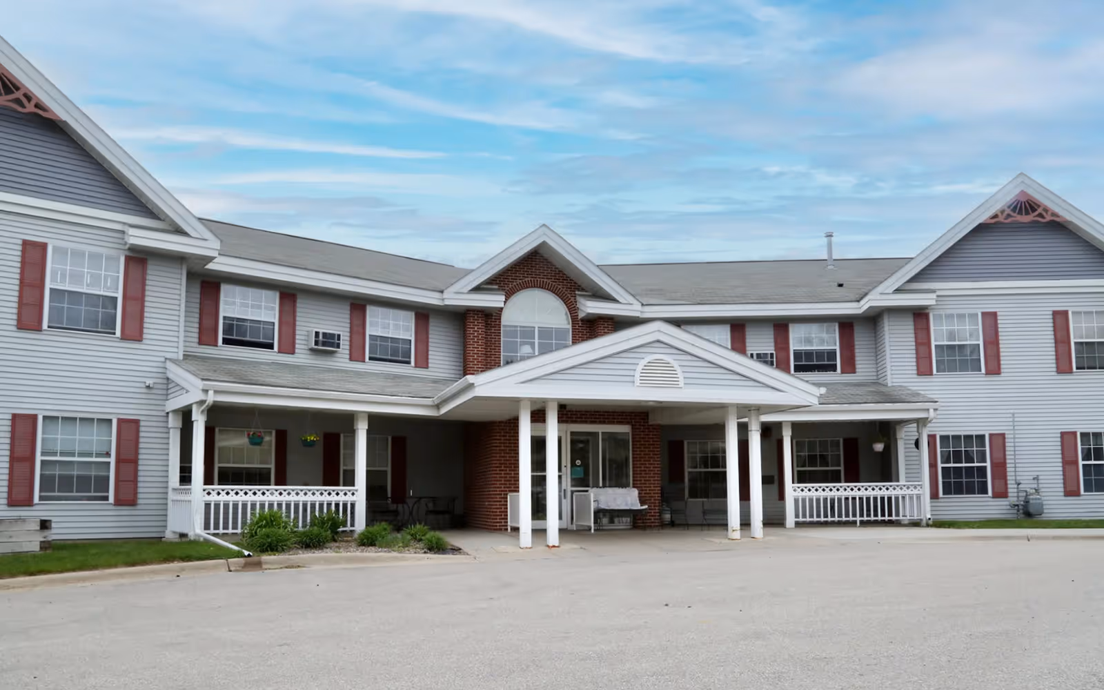 The front exterior of Pine Haven Care Center featuring a two-story building with a covered entrance.