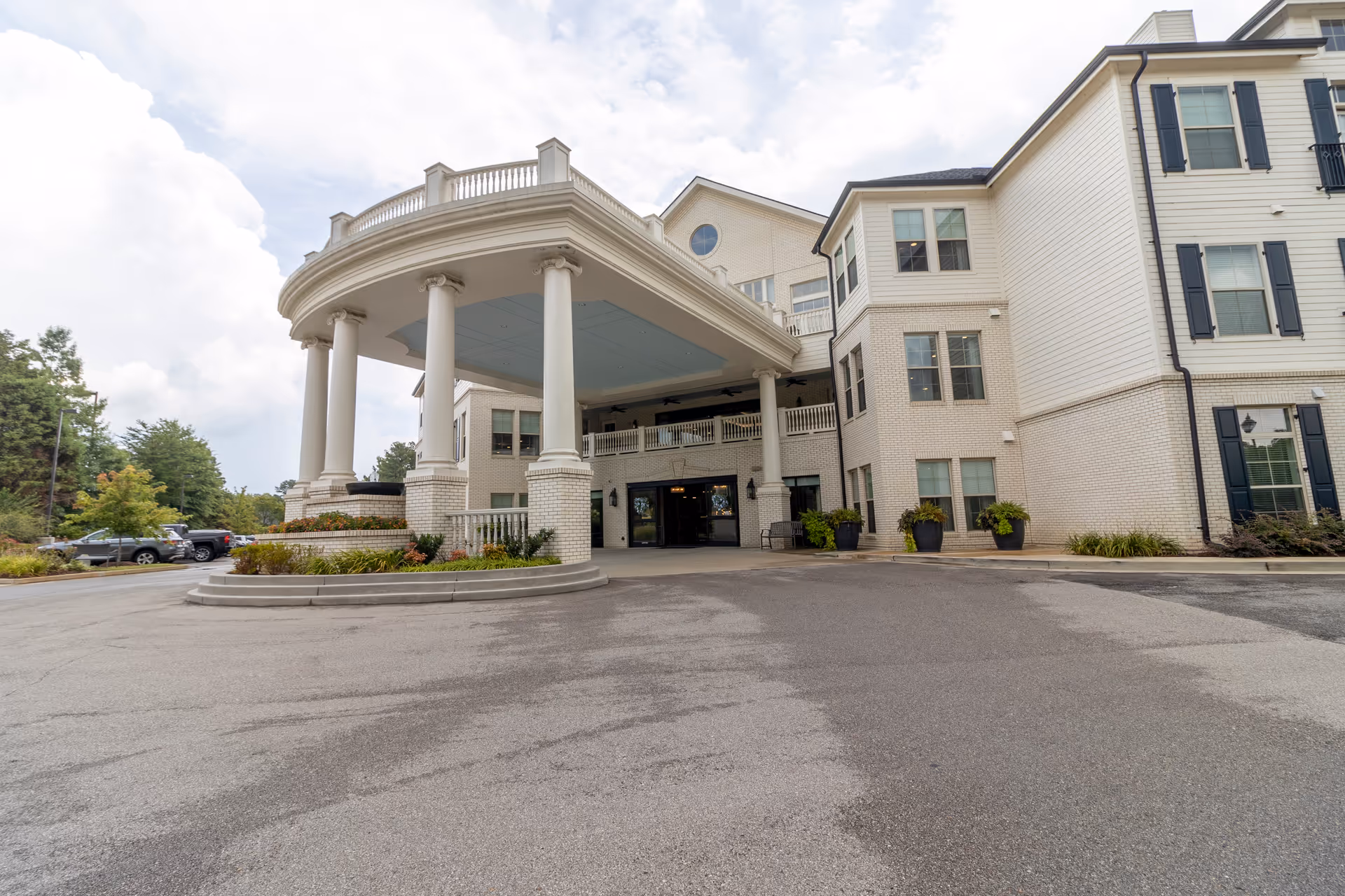Exterior view of StoryPoint Germantown entrance with a circular portico and parked cars
