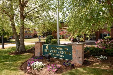 Exterior view of Life Care Center of Auburn with sign and landscaped front.