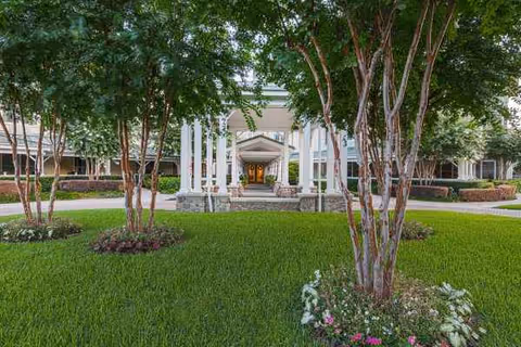 Sunrise on Hillcrest exterior entrance with path, columns, and green landscaping