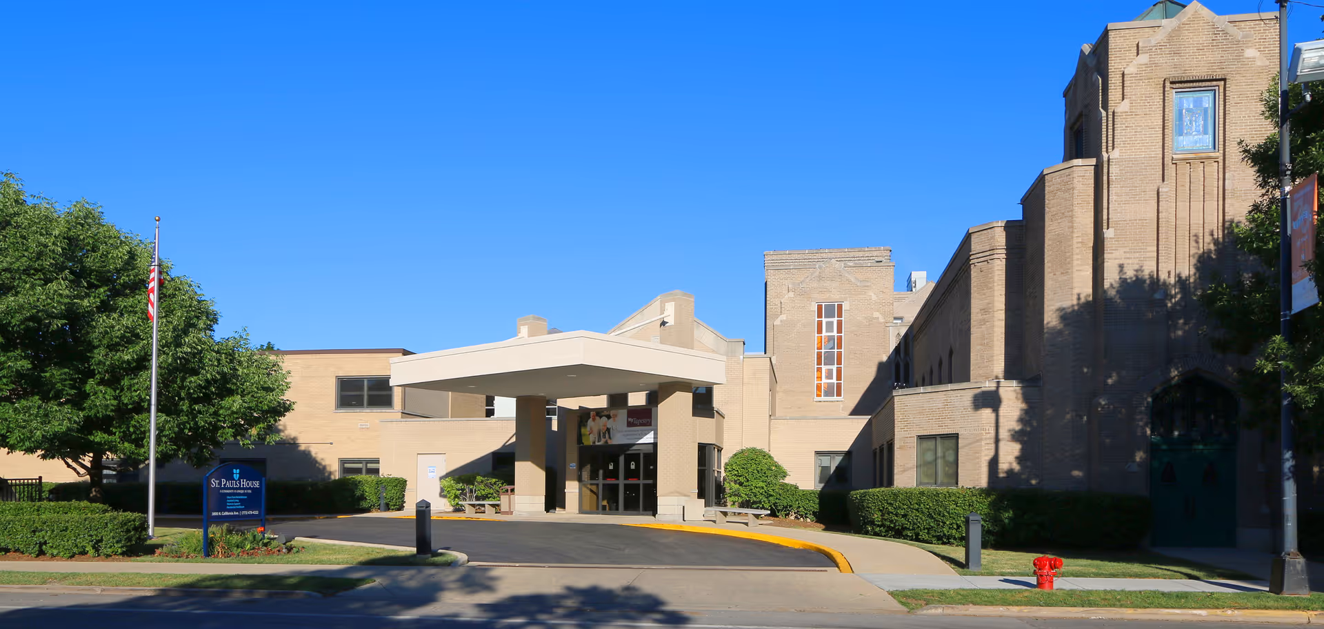 Exterior view of Paul House and Healthcare Center with entrance canopy and landscaped grounds.