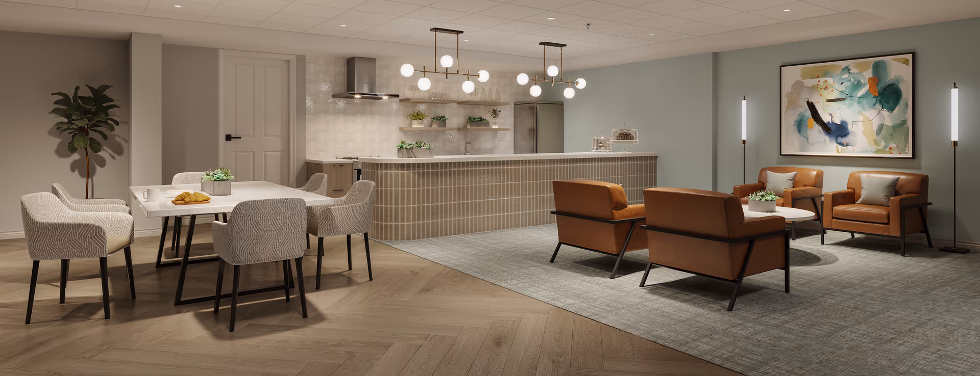 A modern open-concept living and dining area in a senior living facility. The space features a dining table with six upholstered chairs, a kitchen island with pendant lighting, and a seating area with four brown leather armchairs around a coffee table. The walls are decorated with a large abstract painting and two tall floor lamps, and there are plants placed on the table and kitchen shelves.