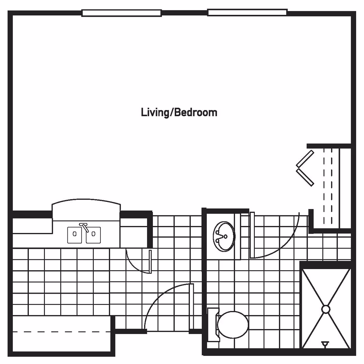 Architectural floor plan showing a studio layout with a combined living and bedroom area, a kitchen with a sink, and a bathroom with a toilet, sink, and shower.