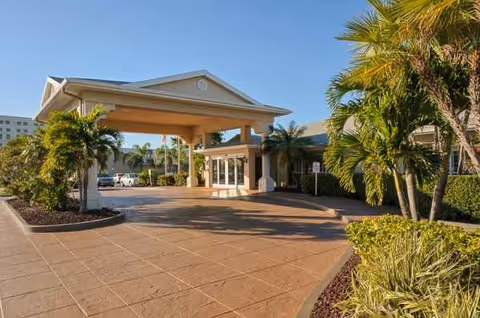 Front entrance to Life Care Center Melbourne with a porte-cochere and palm trees