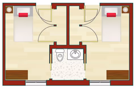 Floor plan showing two adjacent bedrooms, each with a bed, nightstand, and a shared bathroom in the center containing a toilet and a sink.