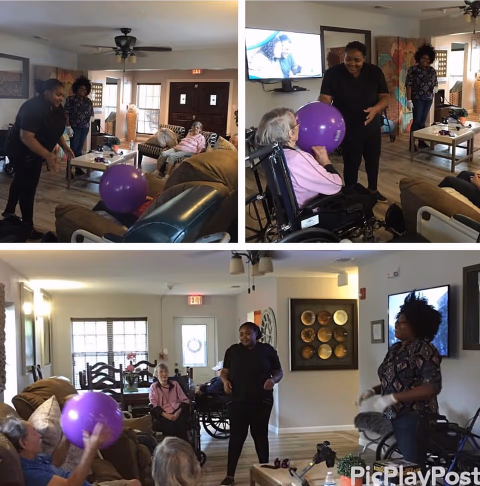 A collage of three images showing a group of elderly residents and caregivers in a living room setting. The residents, some in wheelchairs, are engaging in a playful activity with a large purple ball. The room is furnished with couches, a coffee table, and a TV mounted on the wall. Caregivers are interacting warmly with the residents, creating a lively and friendly atmosphere.