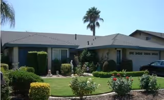 Front view of All in Carehome, a single-story facility with manicured lawn.
