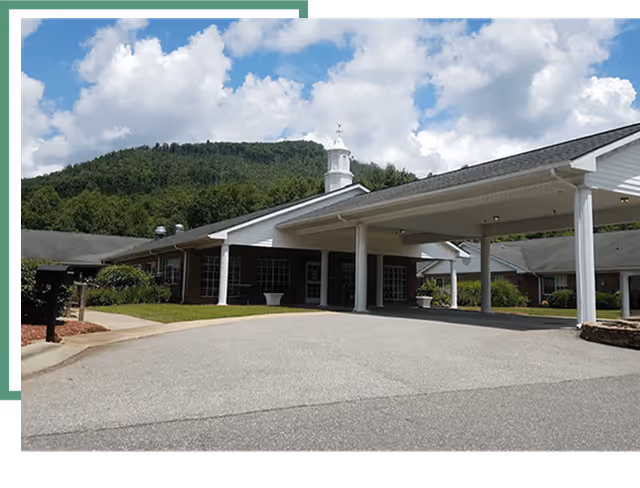 Front entrance of Mountain Ridge Wellness Center with a covered driveway and hillside backdrop.