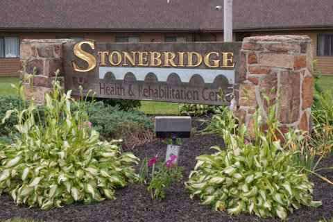 Stonebridge Health & Rehabilitation Center sign with stone pillars and greenery